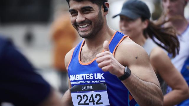Male runner in a Diabetes UK vest, putting a thumb up to the camera.