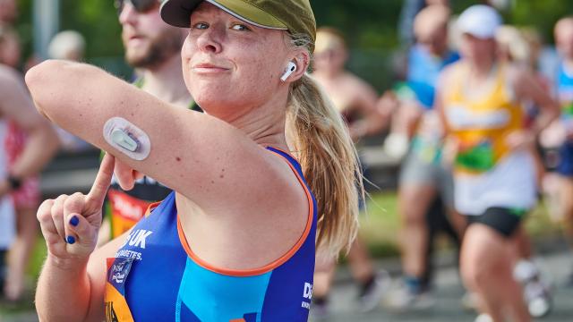 A female runner pointing to diabetes tech.