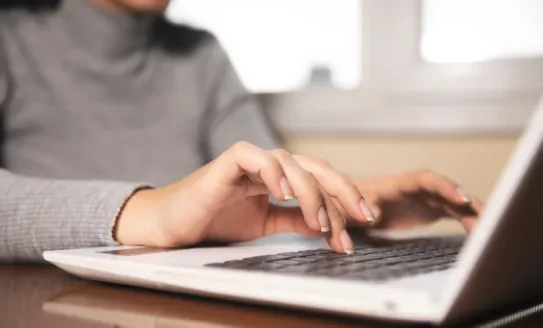 Woman typing on laptop