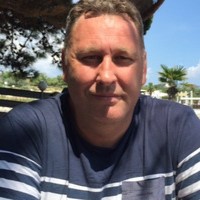 Image of Alan sat in the sunshine.