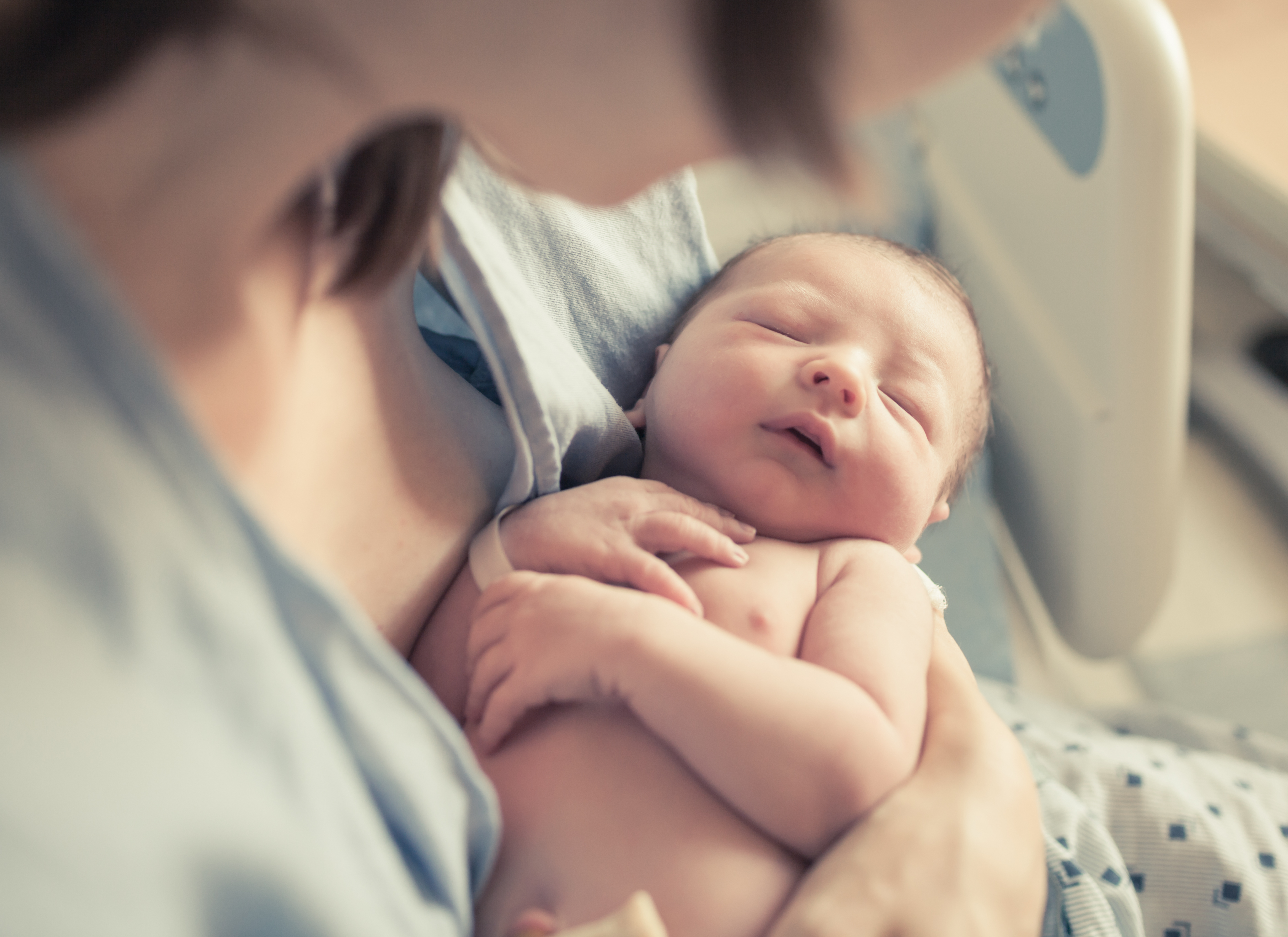woman holding new born baby