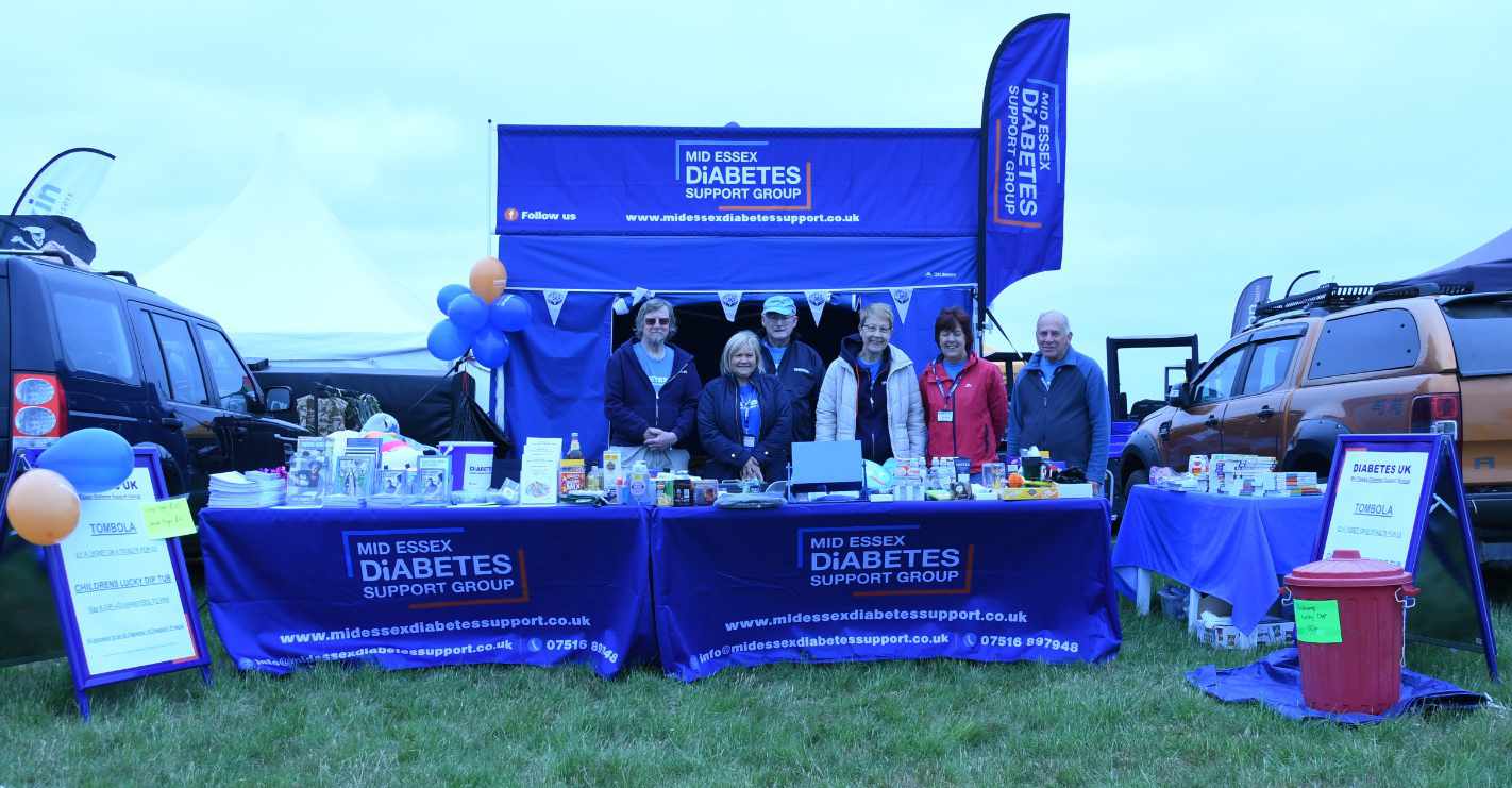 Photo of Diabetes UK support group stood behind a stand fundraising.