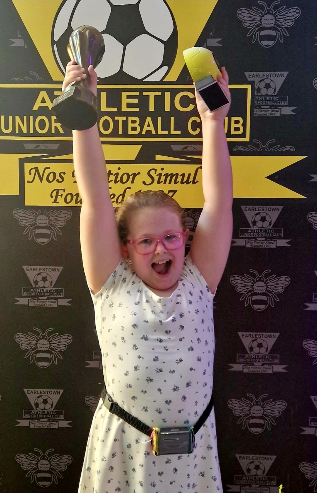 Gracie celebrating and holding a trophy