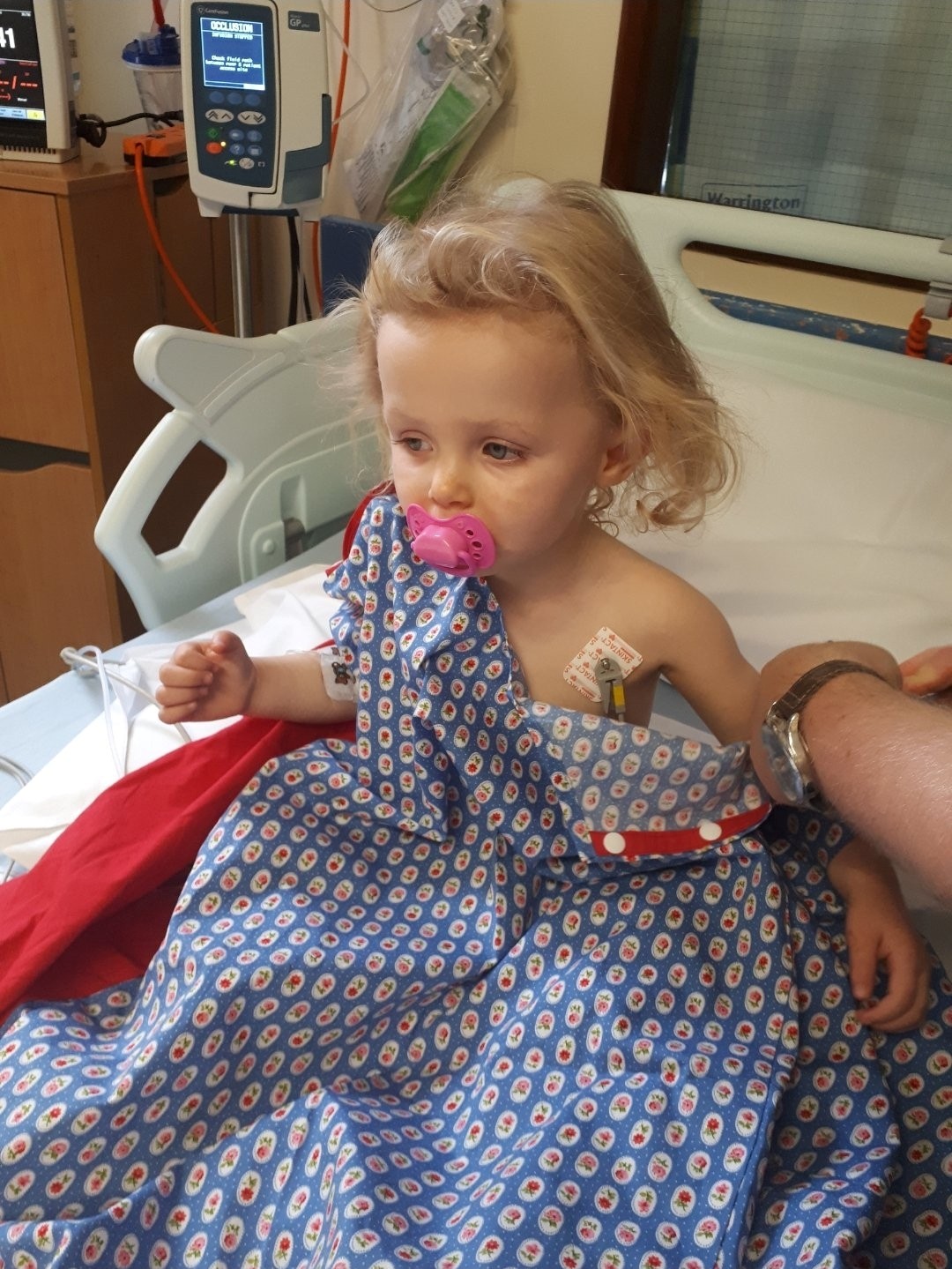 Gracie sat in a hospital bed