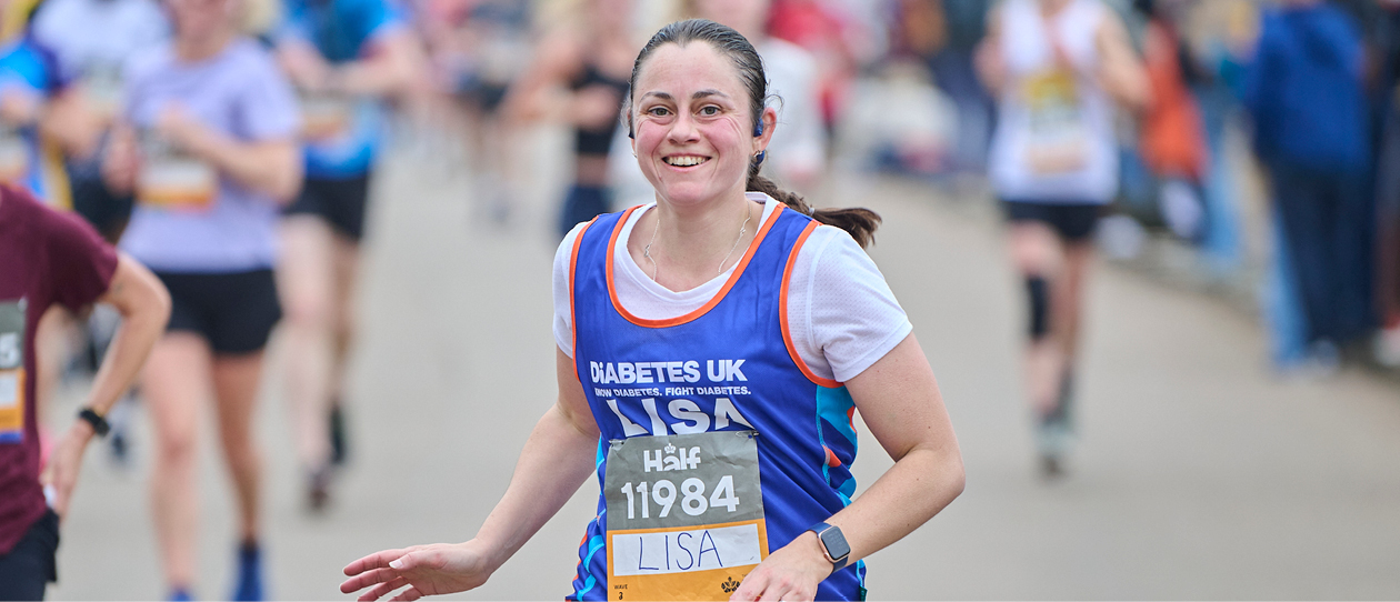 Female runner in Diabetes UK jersey smiling at the camera.