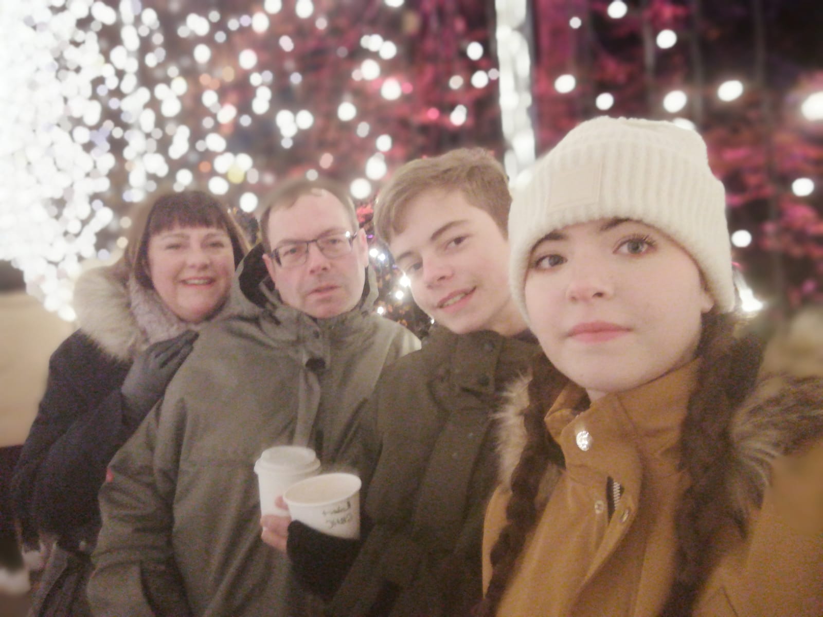 Family photograph pictured in front of Christmas lights 