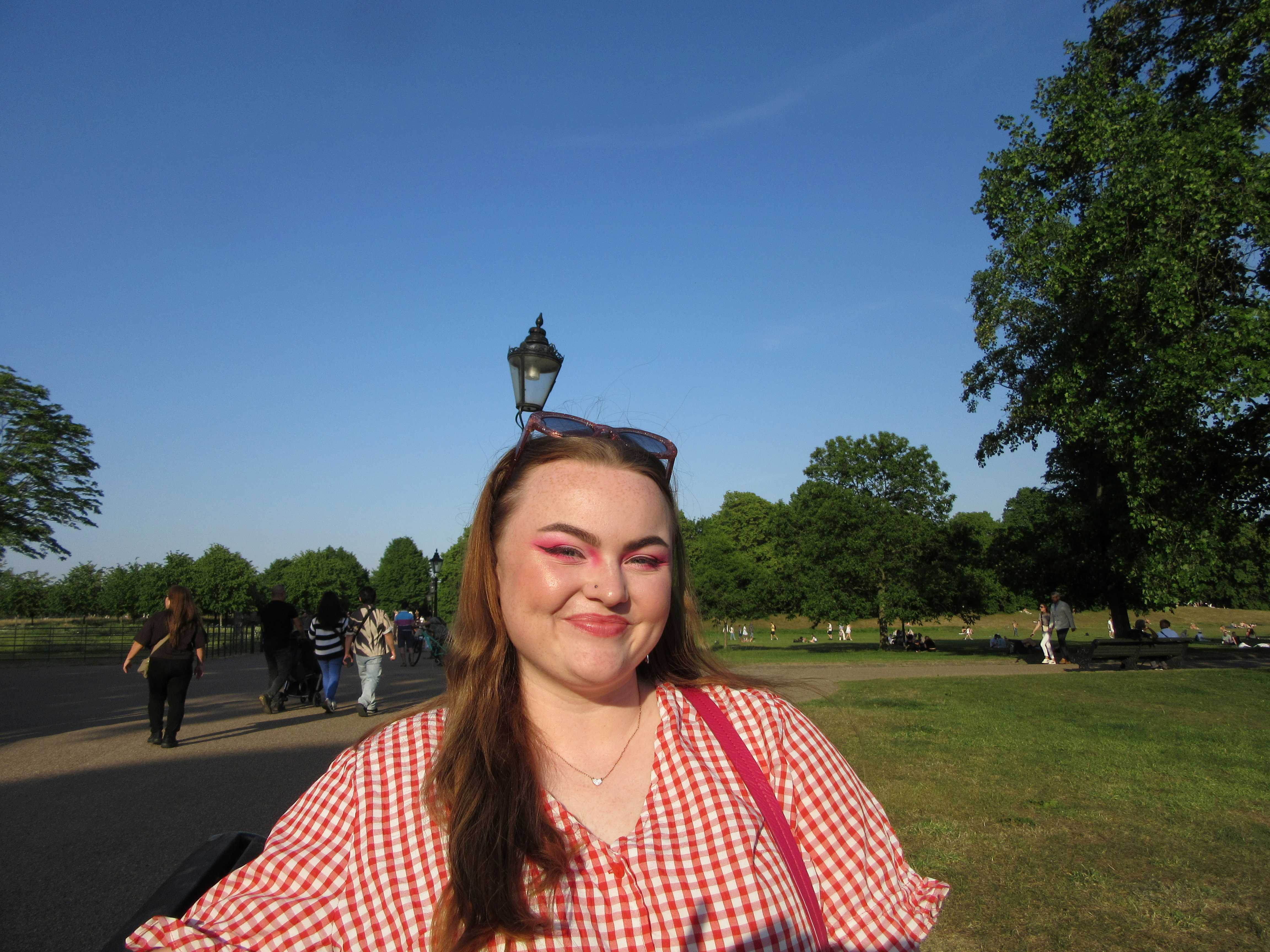 Beth pictured smiling in a sunny park