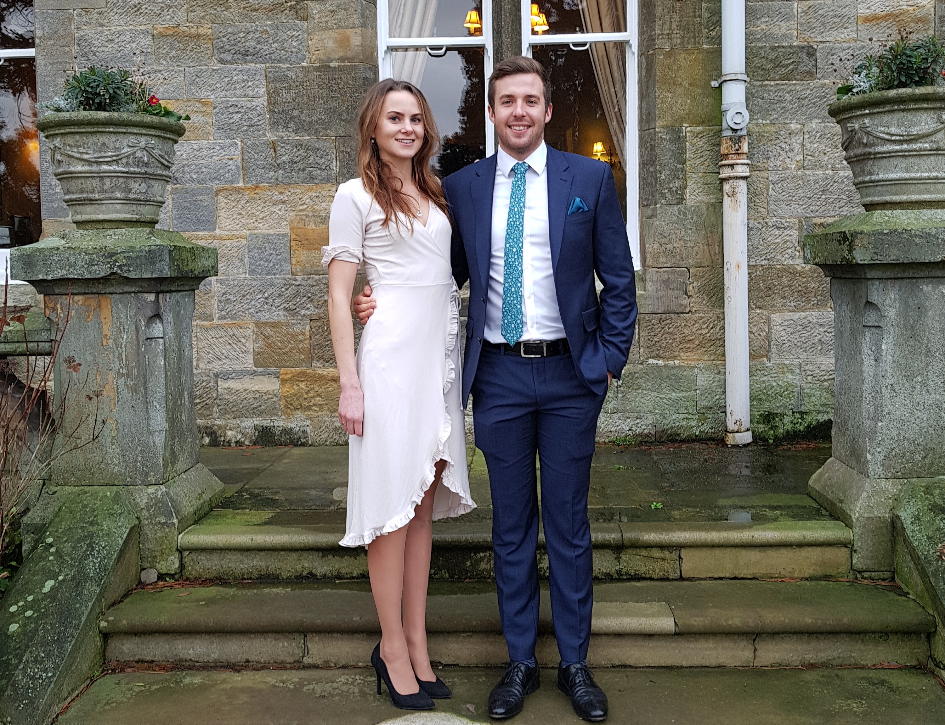 Emily stood on steps with her partner