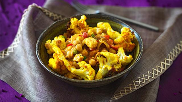 Bowl of roasted cauliflower, paneer and chickpea curry