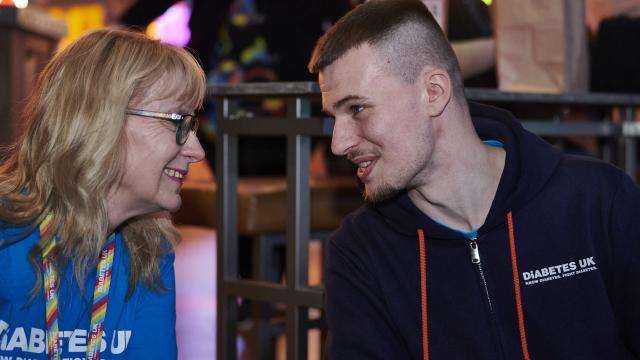 man talks to woman at diabetes uk event 