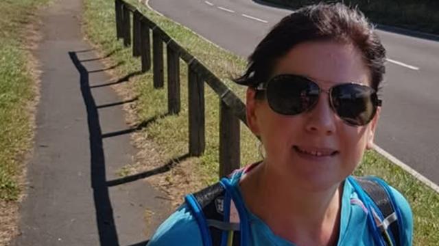 Volunteer Vicky Greenbank, pictured wearing sunglasses and a blue t shirt 