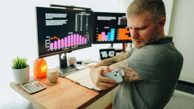 man scanning sensor in front of computer