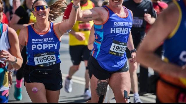 Man and woman holding hands wearing Diabetes UK running vest