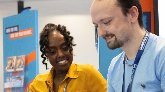 A woman and man looking at a laptop at the Diabetes UK professional conference