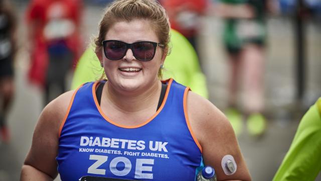 Female Runner with sunglasses smiling at the camera