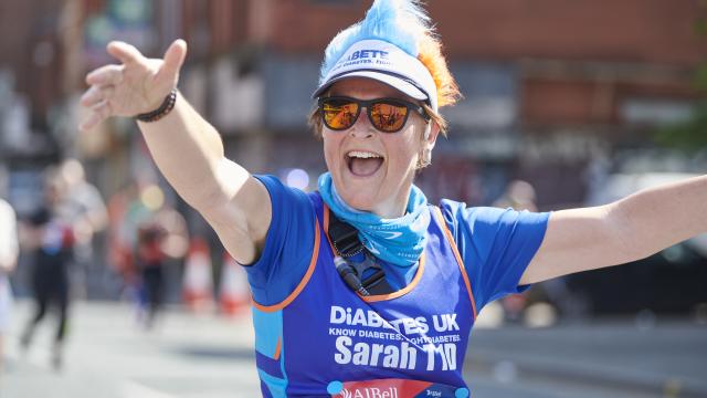 Woman waving at camera in Diabetes UK vest