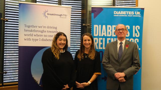 Campaigners in front of a Diabetes UK banner and a Breakthrough T1D banner