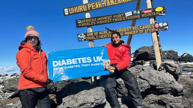 Two hikers at the top of Kilimanjaro 
