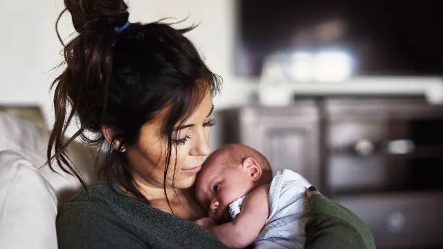 Mum cuddling new baby