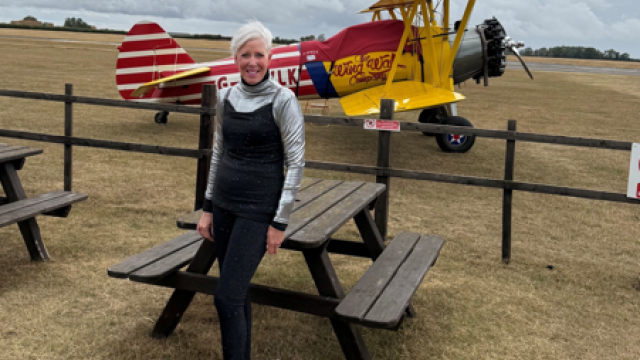 Woman standing by a plane 
