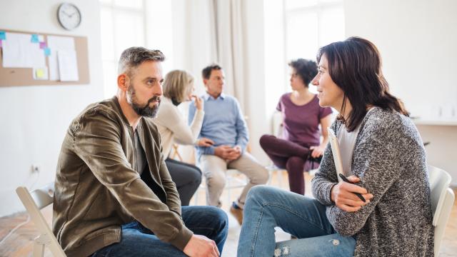 two adults in a waiting room