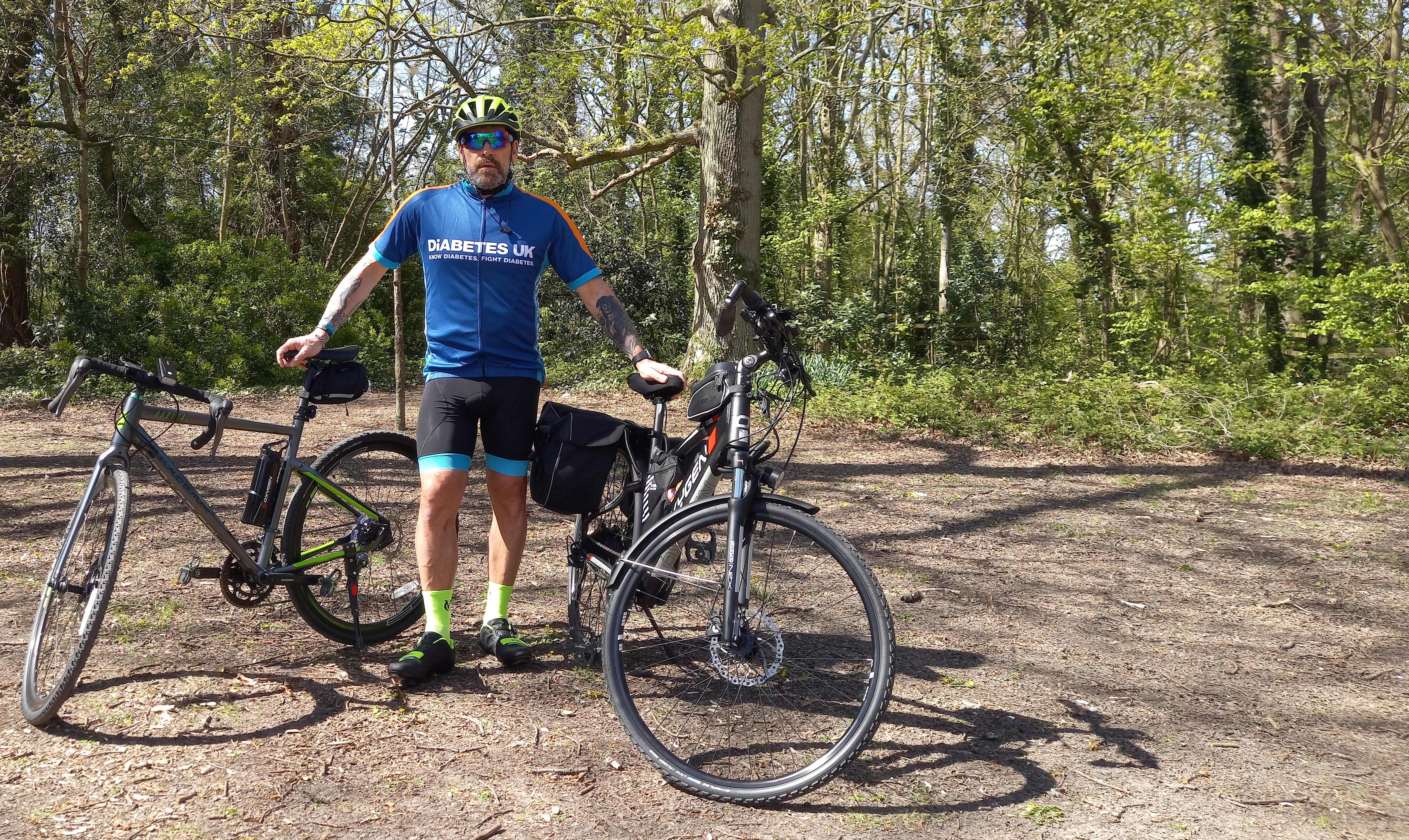 Brian wearing his Diabetes UK top and standing with his bike