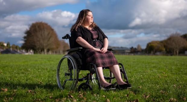 Michelle in wheelchair looking away from camera
