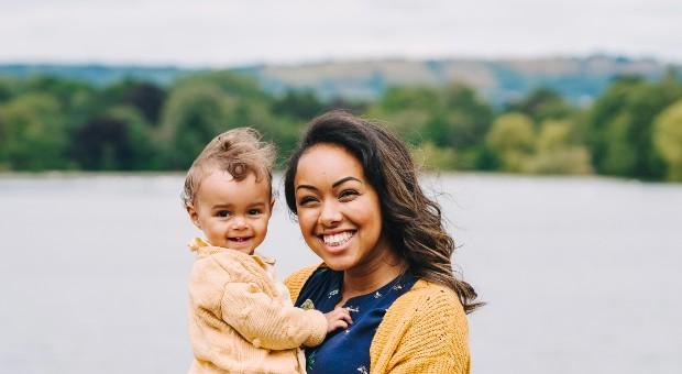 Mel holding her daughter smiling