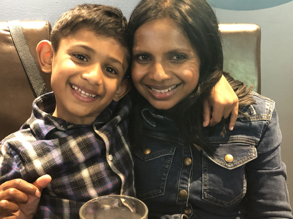 Prity and her son smile at the camera