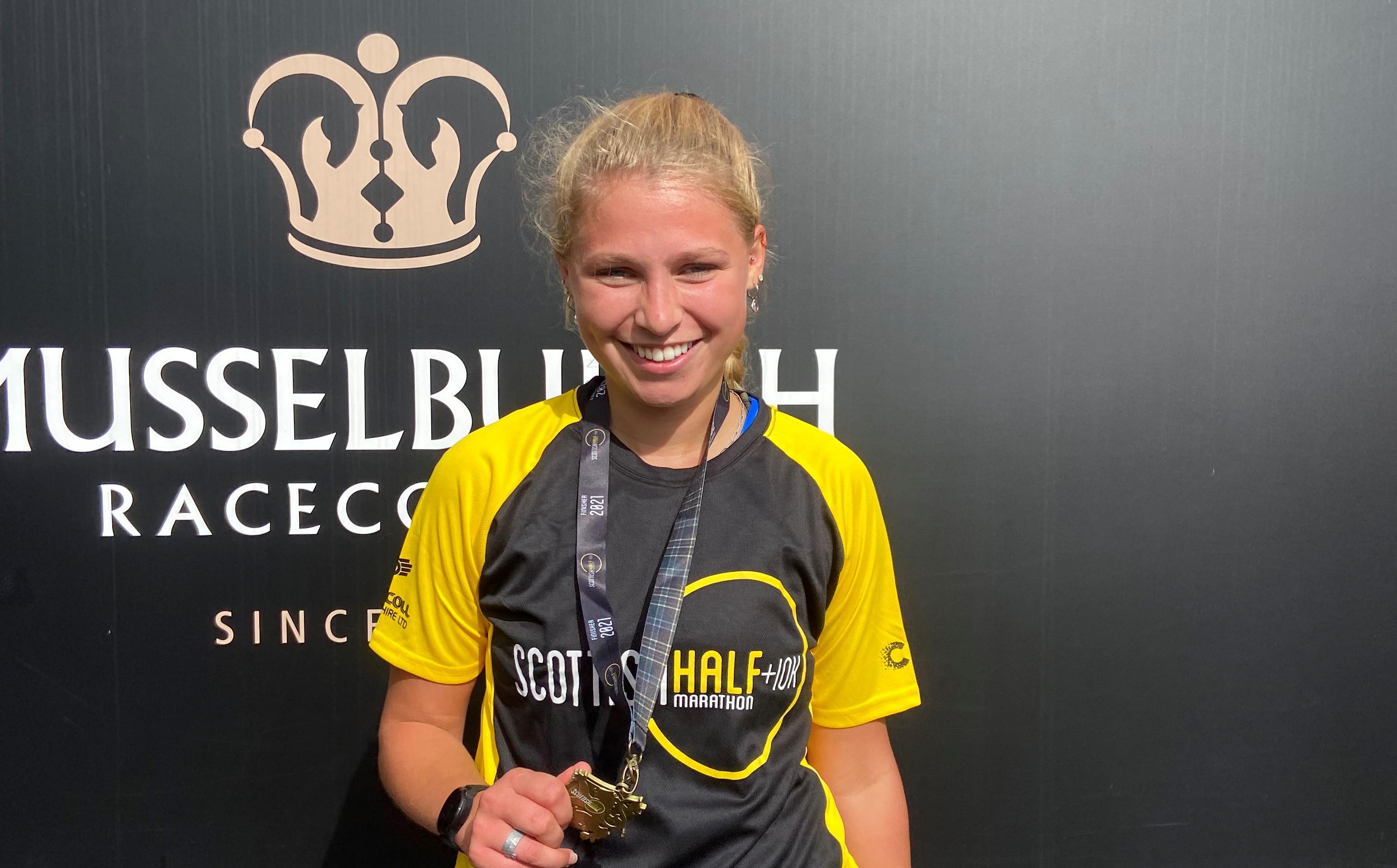 Image of Grace with a medal for a half marathon