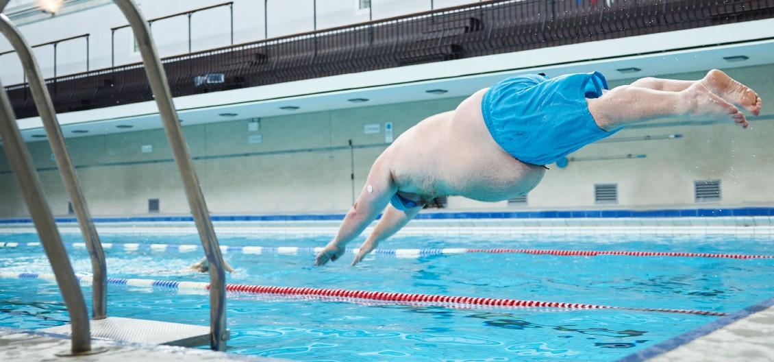 man diving into pool