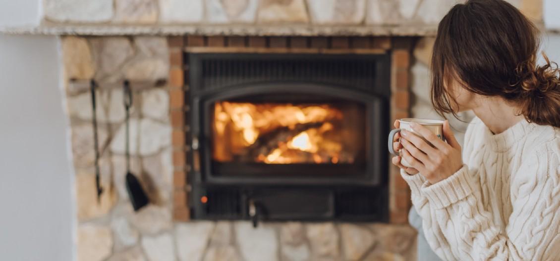 young woman sitting in front of fire