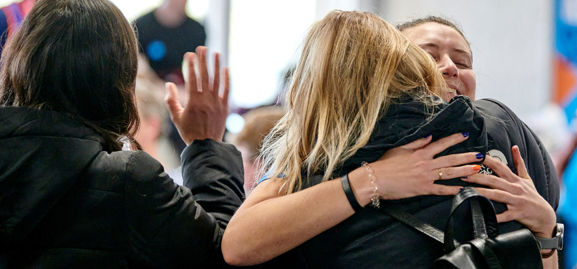 two women hug 
