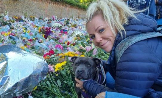 lady looking at flowers with her dog