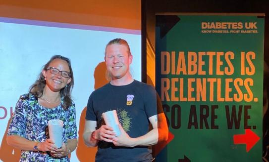 Dr Chloe Rackham and Dr Craig Beall receiving a pint glass each