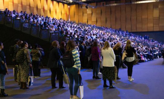 A crowd at a packed-out lecture theatre