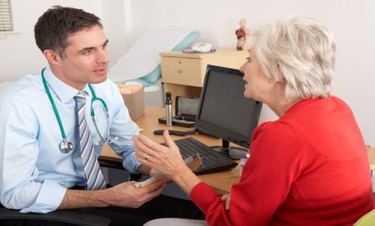doctor talking to female patient 