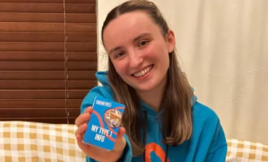 amelia holding a 'My Type 1 Info' card