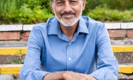 Man sitting on steps with arms crossed