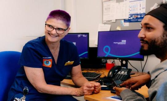 Nurse smiling interacting with a patient
