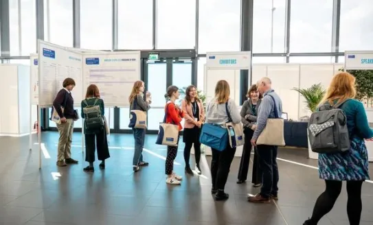 People walking around at a busy conference 