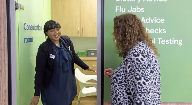 A Tesco pharmacist greeting patient