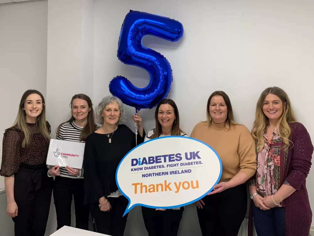 Diabetes UK Northern Ireland staff with a 5 balloon