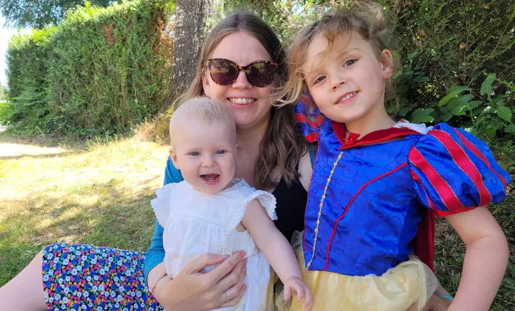 Mother with two young children outside