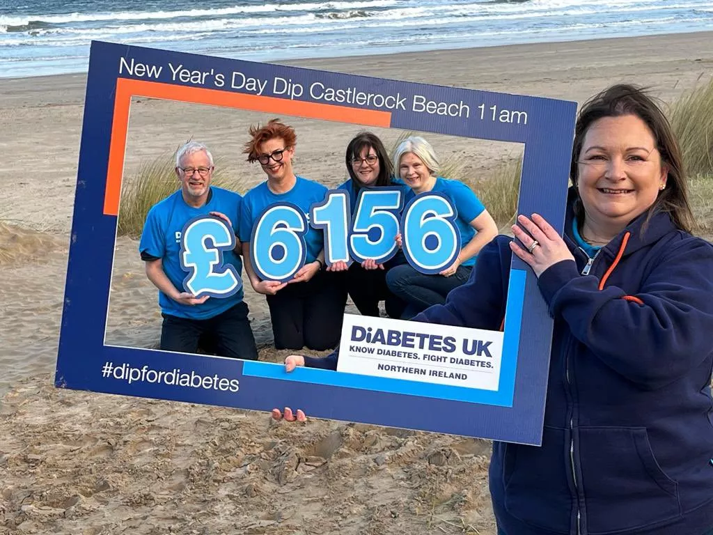 Image of Naomi and the Coleraine Support Group with the total of £6,156