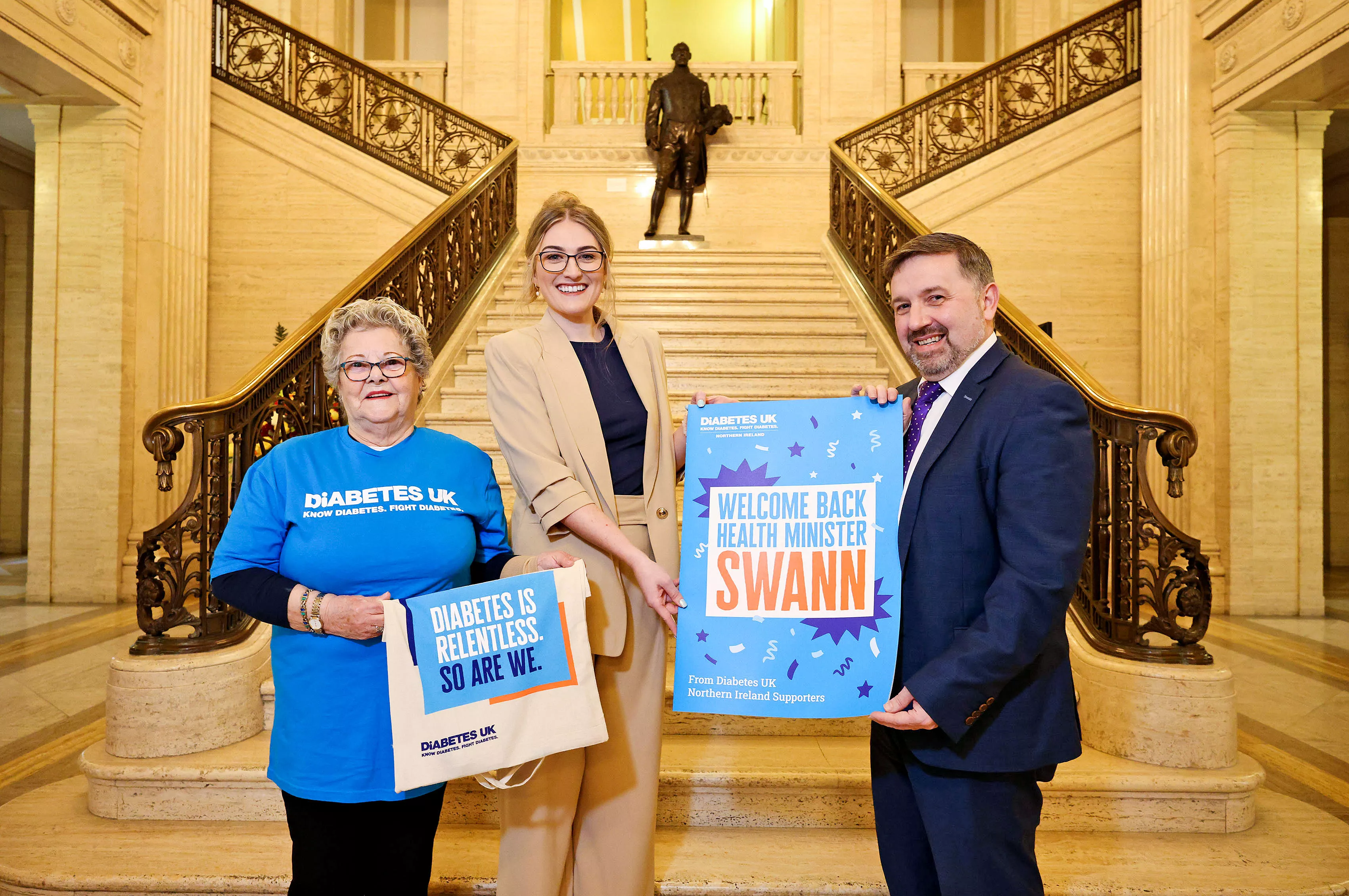 NI National Director Roxanne Small pictured at the Great Hall in Stormont with Health Minister Robin Swan and local volunteer Jean Bradshaw