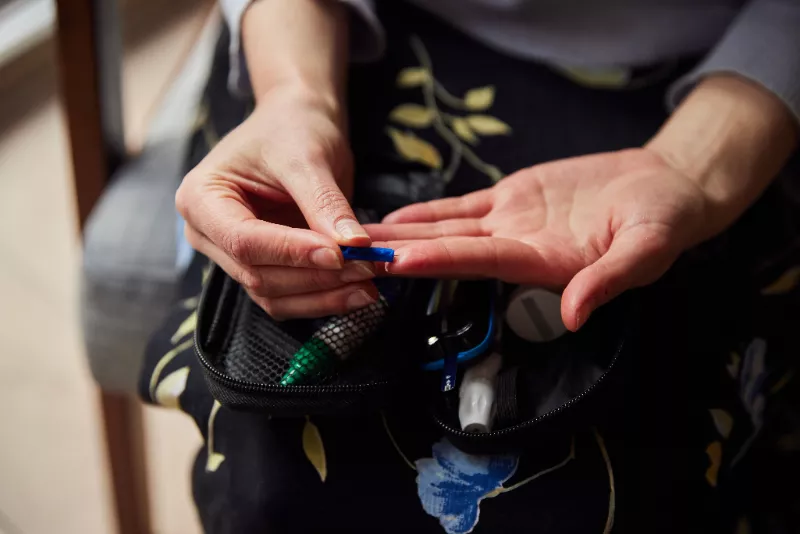 A person checking their blood glucose levels