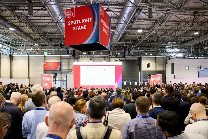 A crowd of researchers gathered around a speaker at EASD
