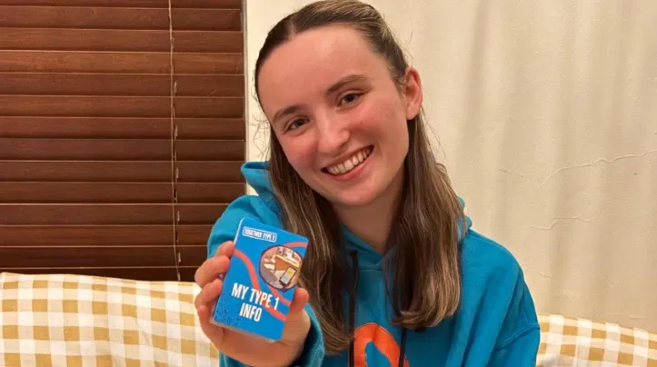 amelia holding a 'My Type 1 Info' card