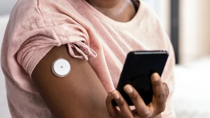 Woman checking CGM